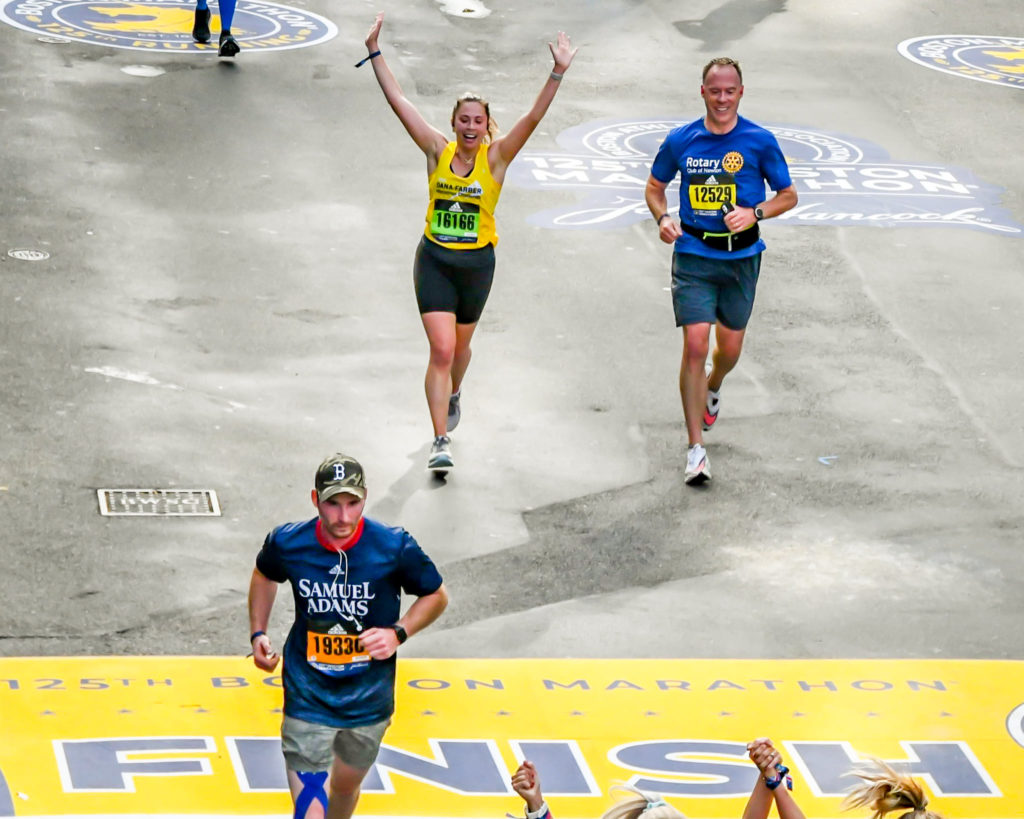 Jack Prior approaching the 125th Boston Marathon finish line in a Rotary Club of Newton shirt
