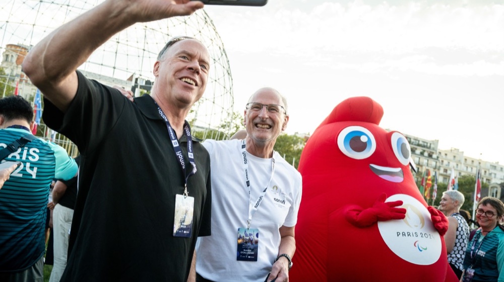 Jack Prior volunteering at Paris 2024 with the Phryge mascot